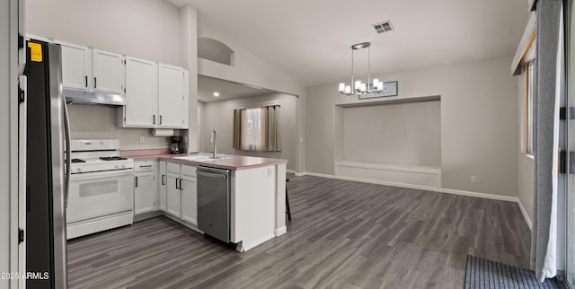 kitchen featuring white cabinetry, kitchen peninsula, appliances with stainless steel finishes, hanging light fixtures, and sink