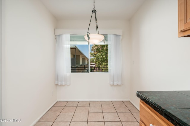 330 W Maryland Ave Unit 207, Phoenix, AZ 85013 - unfurnished dining area with light tile patterned floors and baseboards
