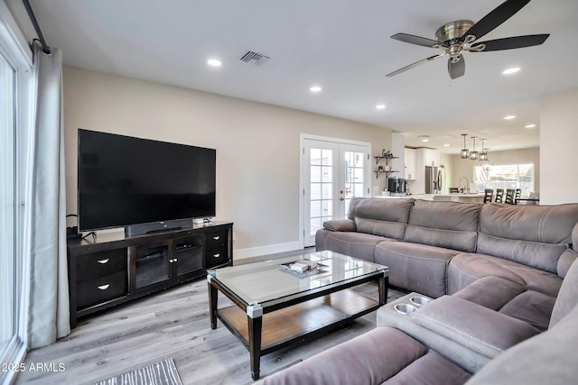 living room featuring french doors, recessed lighting, visible vents, light wood-style floors, and baseboards