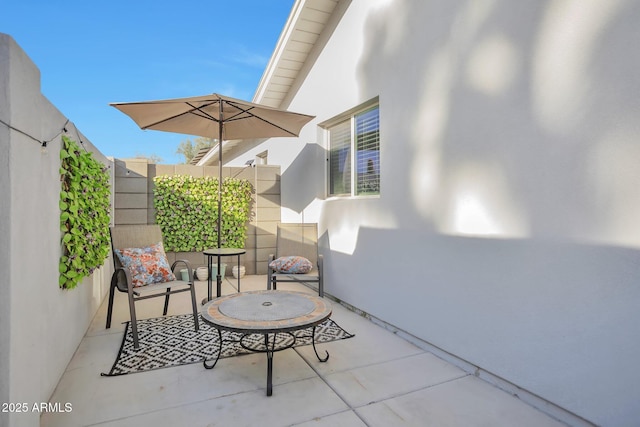 view of patio featuring fence