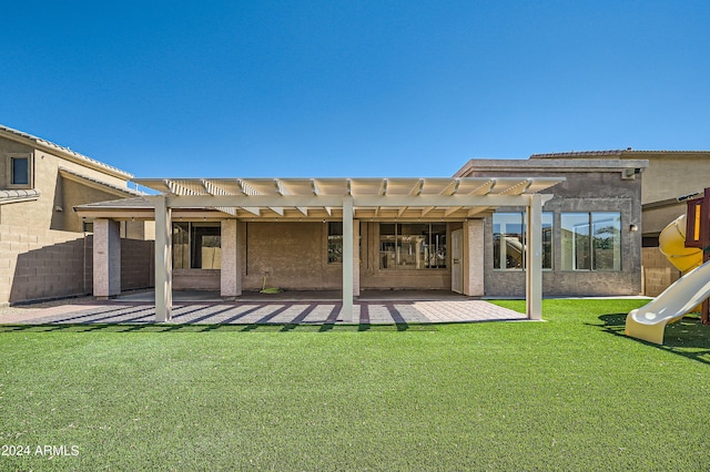 rear view of house featuring a yard, fence, a pergola, and a patio