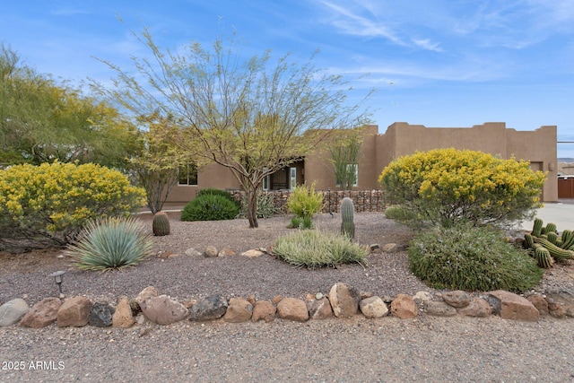 pueblo revival-style home featuring stucco siding