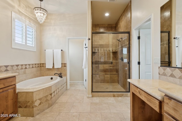 full bath featuring tile patterned floors, visible vents, a garden tub, a shower stall, and vanity