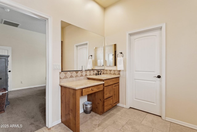 bathroom with visible vents, backsplash, tile patterned flooring, baseboards, and vanity