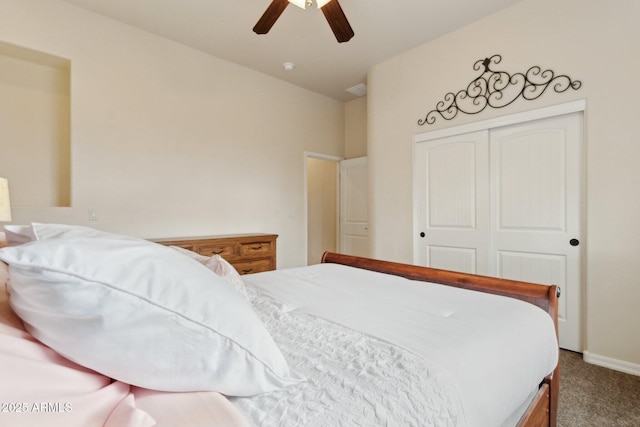 carpeted bedroom featuring a closet, lofted ceiling, and a ceiling fan