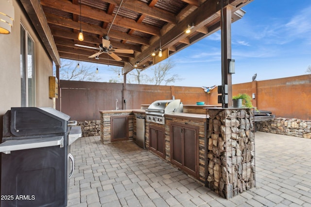 view of patio with area for grilling, a fenced backyard, and a grill