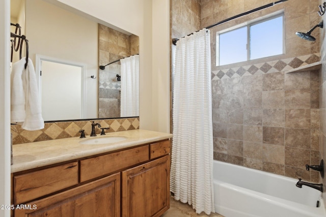 full bath with vanity, shower / tub combo, and tasteful backsplash