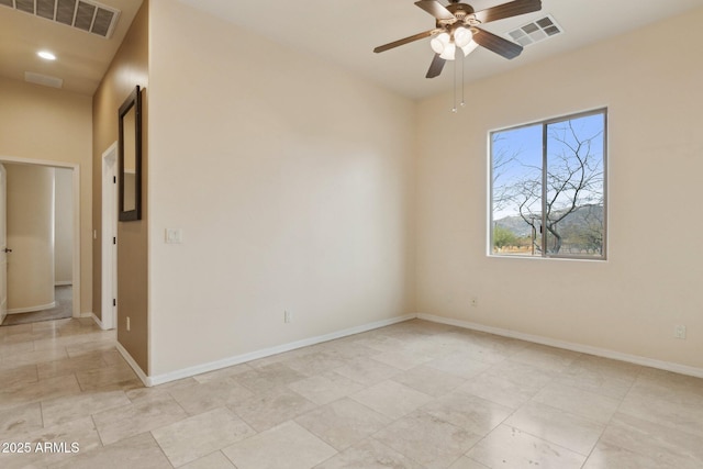 unfurnished room with baseboards, visible vents, and ceiling fan