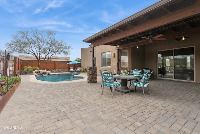 view of patio with outdoor dining space, ceiling fan, a fenced backyard, and a fenced in pool