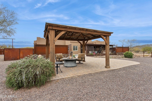 view of patio / terrace featuring a gazebo, an outdoor fire pit, and fence