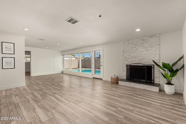 unfurnished living room with visible vents, recessed lighting, and light wood-style flooring