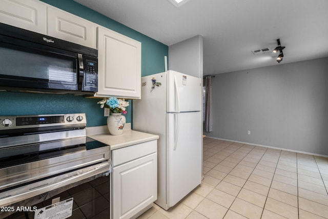 kitchen with rail lighting, white cabinetry, stainless steel range with electric stovetop, white fridge, and light tile patterned floors