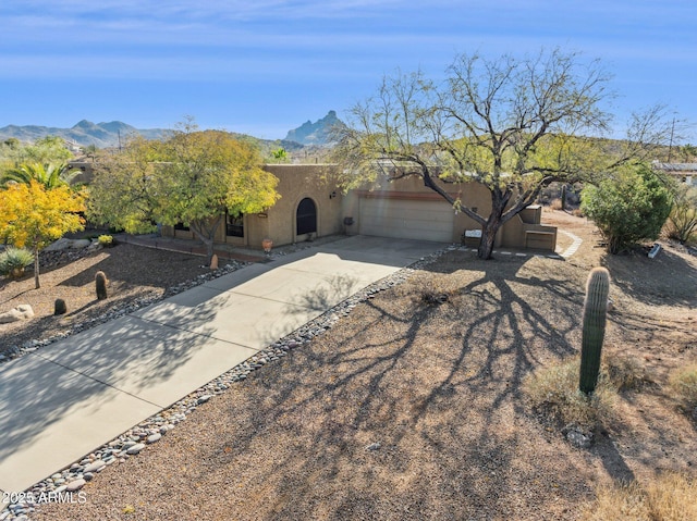 view of front of property with a garage and a mountain view