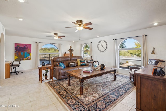 tiled living room featuring ceiling fan