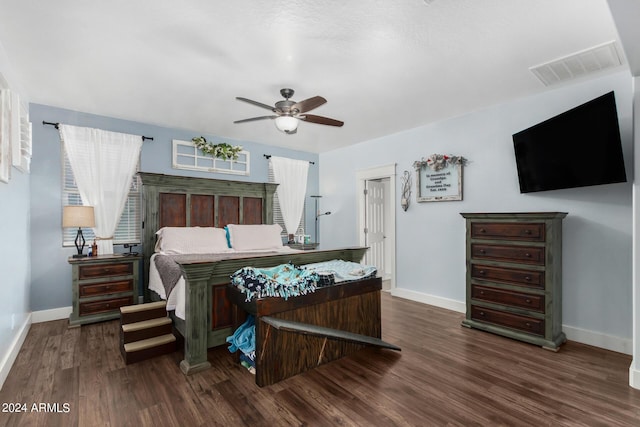 bedroom featuring dark wood-style floors, visible vents, and baseboards