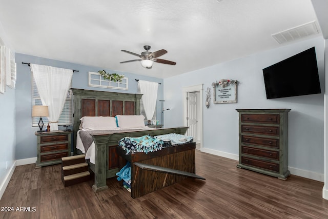 bedroom with ceiling fan and dark hardwood / wood-style flooring