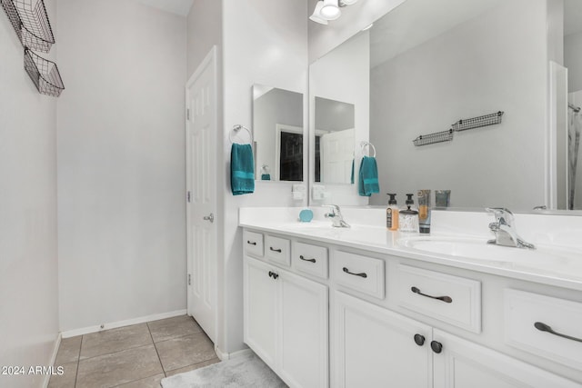 full bathroom featuring tile patterned flooring, a closet, a sink, and double vanity