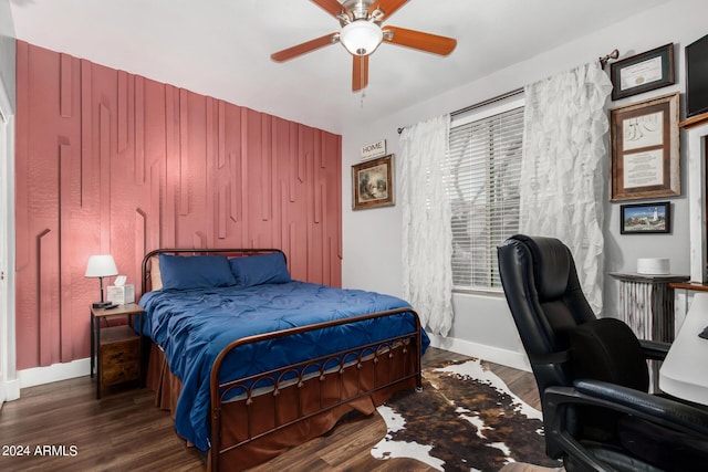 bedroom featuring a ceiling fan, dark wood-style flooring, and baseboards