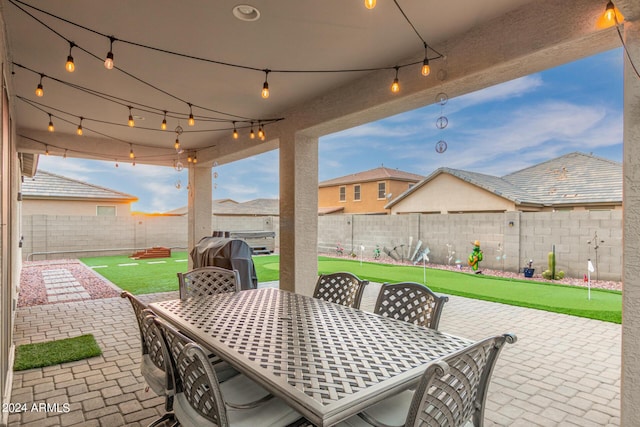 view of patio with outdoor dining area, a fenced backyard, and area for grilling