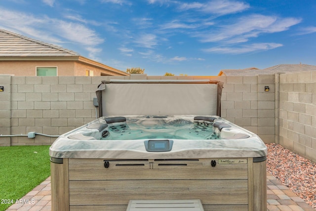 exterior space with a hot tub and fence