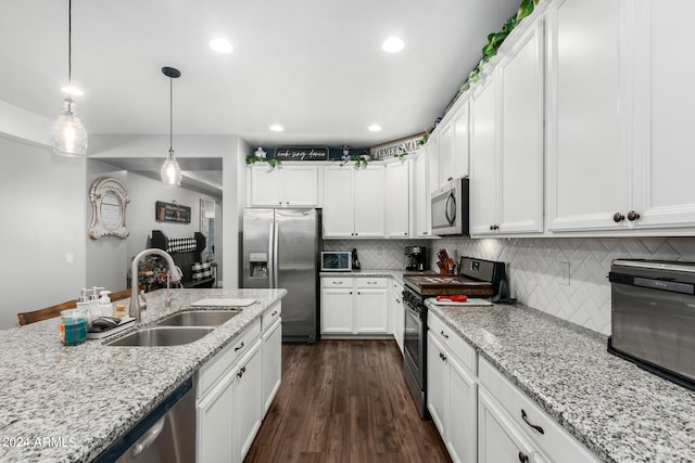 kitchen featuring dark hardwood / wood-style floors, stainless steel appliances, sink, decorative backsplash, and white cabinets