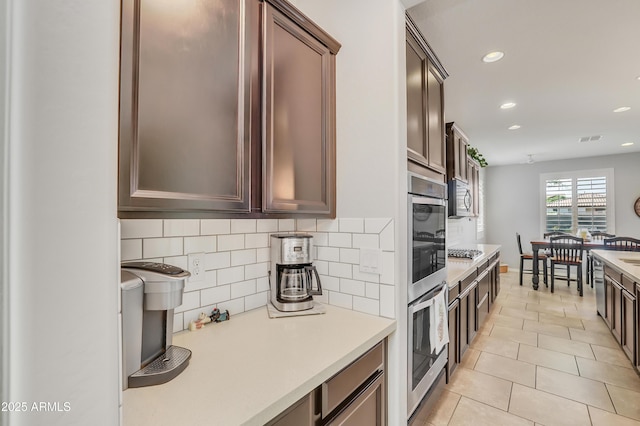 4229 W Magdalena Ln, Laveen, AZ 85339 - kitchen with tasteful backsplash, light countertops, light tile patterned floors, stainless steel appliances, and recessed lighting