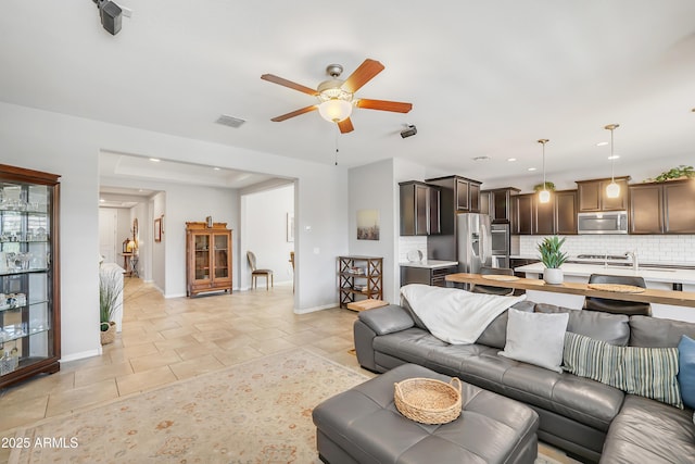 4229 W Magdalena Ln, Laveen, AZ 85339 - living room featuring light tile patterned flooring, ceiling fan, recessed lighting, baseboards, and visible vents