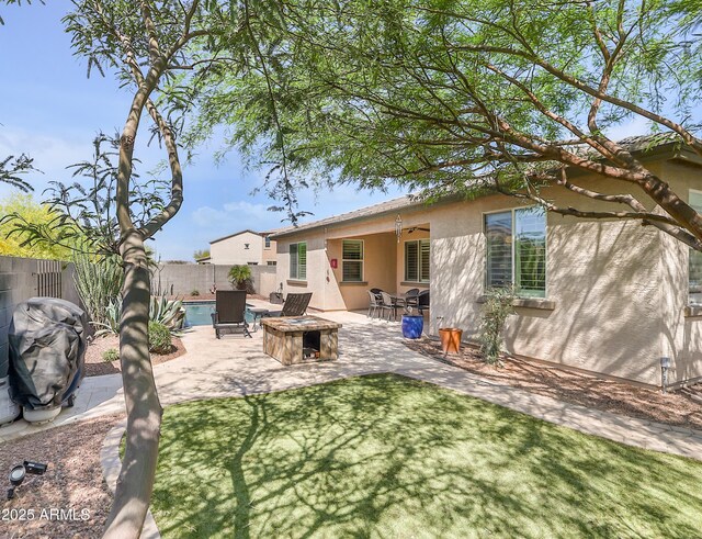 4229 W Magdalena Ln, Laveen, AZ 85339 - back of house with a ceiling fan, a fenced backyard, an outdoor fire pit, a patio, and stucco siding