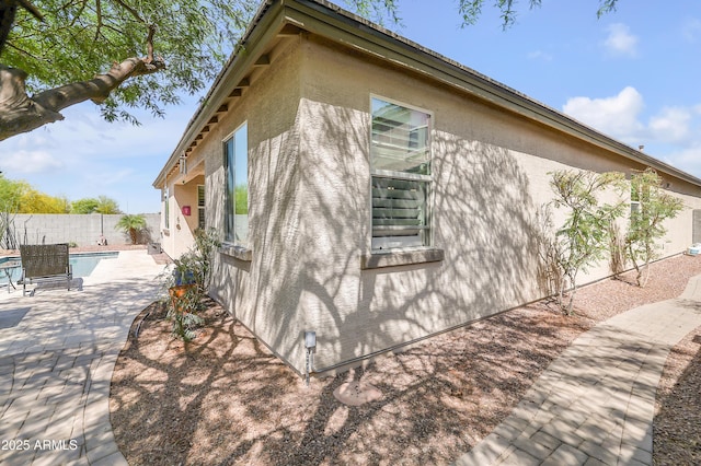 4229 W Magdalena Ln, Laveen, AZ 85339 - view of side of property with a patio, a fenced in pool, a fenced backyard, and stucco siding