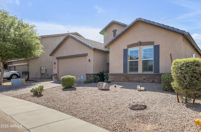 4229 W Magdalena Ln, Laveen, AZ 85339 - view of front facade featuring stone siding, stucco siding, a tiled roof, an attached garage, and driveway