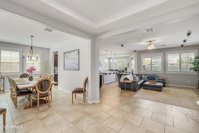 4229 W Magdalena Ln, Laveen, AZ 85339 - dining space featuring light tile patterned floors, baseboards, ceiling fan with notable chandelier, and visible vents