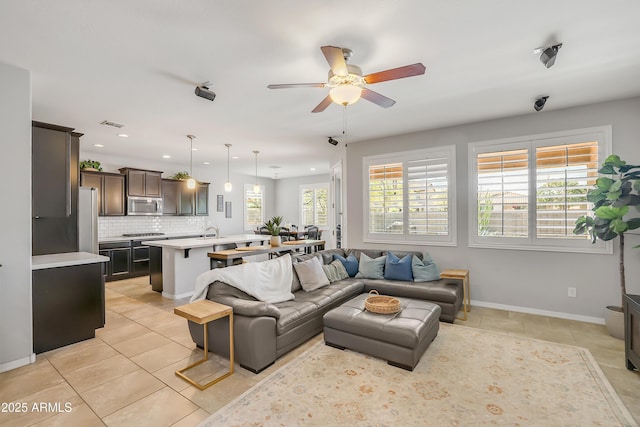 4229 W Magdalena Ln, Laveen, AZ 85339 - living area with ceiling fan, visible vents, light tile patterned floors, baseboards, and recessed lighting