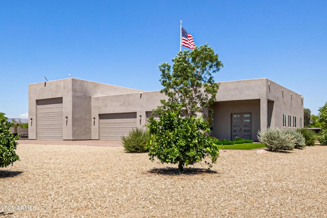 38415 N 25th Ave, Phoenix, AZ 85086 - view of front of property with an attached garage, stucco siding, driveway, and french doors