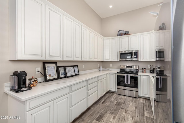 38415 N 25th Ave, Phoenix, AZ 85086 - kitchen featuring stainless steel appliances, light wood finished floors, white cabinetry, light countertops, and recessed lighting