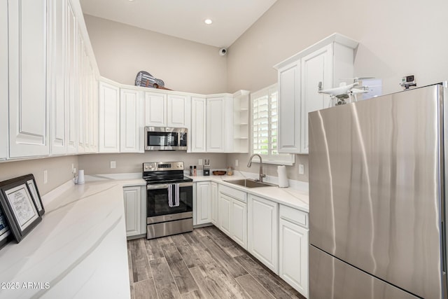 38415 N 25th Ave, Phoenix, AZ 85086 - kitchen featuring stainless steel appliances, white cabinets, open shelves, light wood finished floors, and recessed lighting