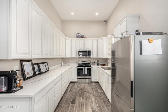38415 N 25th Ave, Phoenix, AZ 85086 - kitchen with stainless steel appliances, light wood finished floors, white cabinetry, and recessed lighting