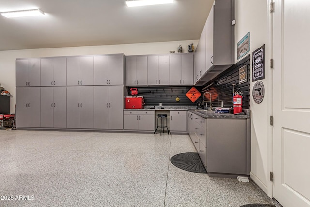 38415 N 25th Ave, Phoenix, AZ 85086 - kitchen with gray cabinetry, dark countertops, dark aggregate flooring, and backsplash