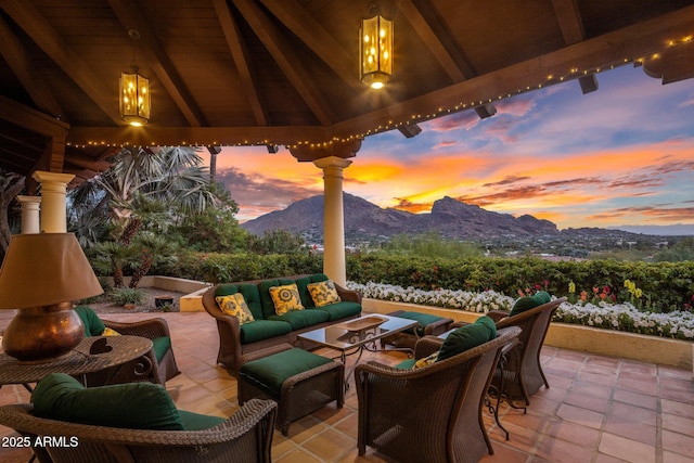 view of patio with an outdoor living space and a mountain view