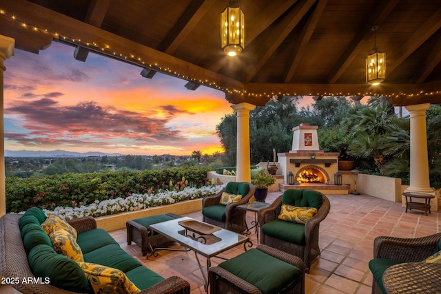 view of patio with a gazebo and an outdoor living space with a fireplace