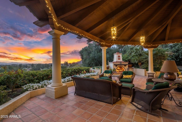 view of patio with a gazebo and an outdoor living space with a fireplace