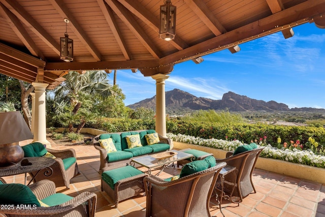 view of patio / terrace featuring a gazebo, a mountain view, and outdoor lounge area