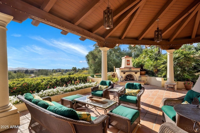 view of patio featuring a gazebo and an outdoor living space with a fireplace