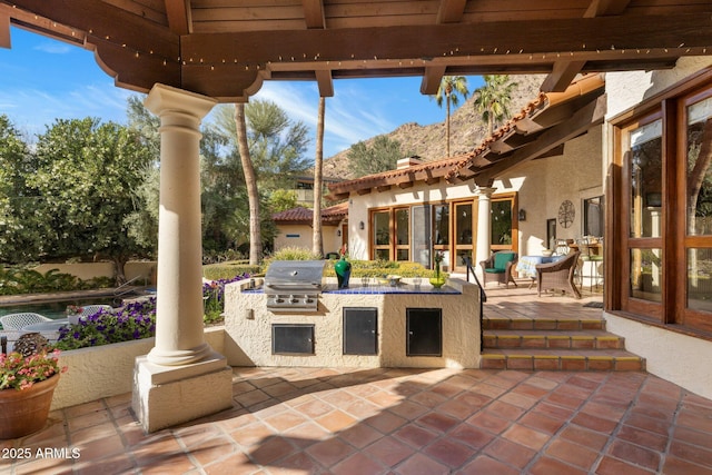 view of patio with a grill and an outdoor kitchen