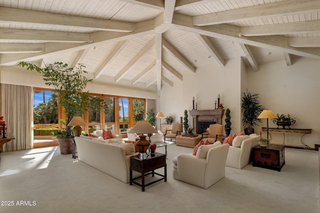 carpeted living area with high vaulted ceiling, plenty of natural light, beamed ceiling, and a lit fireplace