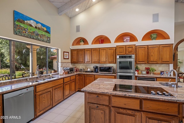 kitchen with a sink, brown cabinets, and appliances with stainless steel finishes