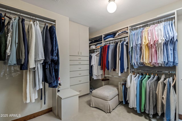 walk in closet featuring light carpet