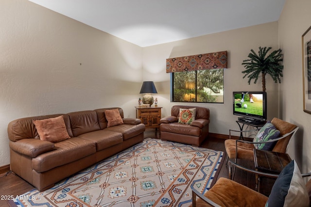 living room featuring baseboards and wood finished floors