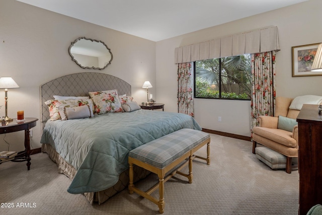 bedroom featuring baseboards and light colored carpet