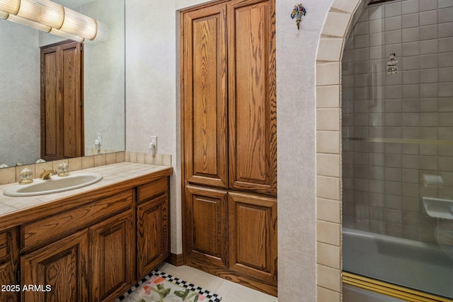 full bathroom with tile patterned floors, vanity, and a shower