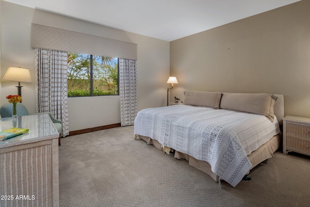 carpeted bedroom featuring baseboards